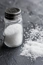 Salt in glass saltcellar on black stone table background Royalty Free Stock Photo