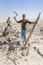 Salt miner working in the salt plains in the Danakil Depression in Ethiopia during winter season.