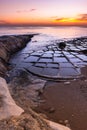 Salt pans at beach in Marsaskala, Malta at sunrise Royalty Free Stock Photo