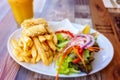 A Calamari Lunch Dish With Chips And Salad