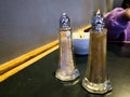 Salt and Pepper Shakers on a Table in a Cozy Diner Setting Royalty Free Stock Photo