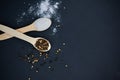 Salt and pepper on wooden spoons Royalty Free Stock Photo