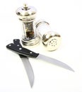 Salt and perpper with knives Royalty Free Stock Photo