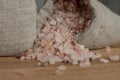 Salt price. Large crystals of pink Himalayan salt, close-up. A coin in a pile of salt as a symbol of rising prices. Royalty Free Stock Photo