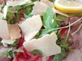 Salt roast beef dish with parmesan flakes, rocket and slice of lemon Royalty Free Stock Photo