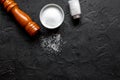 Salt and saltcellar on black stone table background top view mock-up Royalty Free Stock Photo