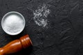 Salt and saltcellar on black stone table background top view mock-up Royalty Free Stock Photo