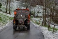 Salt spreader truck in action to avoid the formation of ice on the road