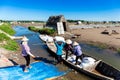 Salt workers transporting salt from field to boat. Location: Hai Hau, Namdinh, Vietnam