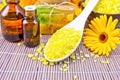 Salt yellow and oil with calendula on bamboo Royalty Free Stock Photo