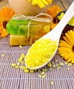 Salt yellow and soap with calendula on bamboo Royalty Free Stock Photo