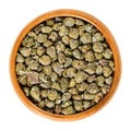 Salted capers in wooden bowl over white Royalty Free Stock Photo