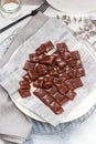 Salted caramel candies cut into square pieces, top view over grey baking paper Royalty Free Stock Photo