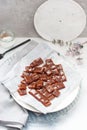 Salted caramel candies cut into square pieces, top view over grey baking paper Royalty Free Stock Photo