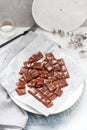 Salted caramel candies cut into square pieces, top view over grey baking paper Royalty Free Stock Photo