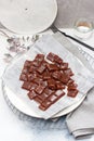 Salted caramel candies cut into square pieces, top view over grey baking paper Royalty Free Stock Photo