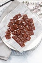 Salted caramel candies cut into square pieces, top view over grey baking paper Royalty Free Stock Photo