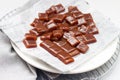 Salted caramel candies cut into square pieces, top view over grey baking paper Royalty Free Stock Photo