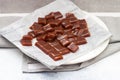 Salted caramel candies cut into square pieces, top view over grey baking paper Royalty Free Stock Photo