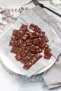 Salted caramel candies cut into square pieces, top view over grey baking paper Royalty Free Stock Photo