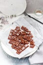 Salted caramel candies cut into square pieces, top view over grey baking paper Royalty Free Stock Photo