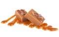 Salted caramel candies with caramel sauce isolated on white background. Toffee candies Royalty Free Stock Photo