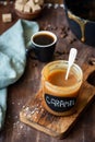 Salted caramel sauce in jar on wooden table