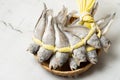 A salted yellow string of dried yellow corvina was placed in a bamboo basket