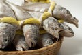 A salted yellow string of dried yellow corvina was placed in a bamboo basket