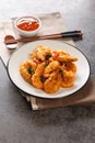 Salted Egg Prawns are rich, creamy and full of umami flavour close-up in a plate. Vertical Royalty Free Stock Photo