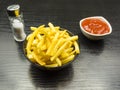 Salted fries and ketchup in a bowl.