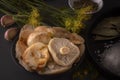 Salted mushrooms on a dark background. Low key. Close-up