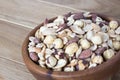 Salted nuts. Salted nuts cocktail on a wooden background. Mix of nuts in a wooden bowl. Copy space. Close-up