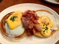 Salted Pancakes with Hollandaise Suace, Eggs and Crispy Bacon for Breakfast. Salty Organic Fast Food served at restaurant. Royalty Free Stock Photo