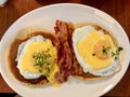 Salted Pancakes with Hollandaise Suace, Eggs and Crispy Bacon for Breakfast. Salty Organic Fast Food served at restaurant. Royalty Free Stock Photo