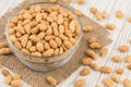 Salted peanuts in a glass bowl on the old wooden table. Royalty Free Stock Photo