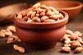 salted peanuts in small, brown bowl