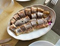 Salted pickled herring fish served on a ceramic plate