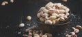 Salted pistachios in bowl, black kitchen table background, selective focus