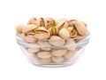 Salted pistachios in a glass bowl isolated on white