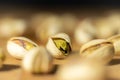 Salted pistachios nuts on a blur and black background.