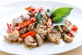 Salted pork with chili & Basil leaves in plate on table. Royalty Free Stock Photo