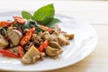 Salted pork with chili & Basil leaves in plate on table. Royalty Free Stock Photo