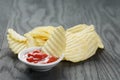 Salted potato ships with sauce on old wooden table Royalty Free Stock Photo