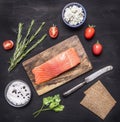 Salted salmon on a cutting board with rosemary, bread for sandwiches, cheese curd and herbs wooden rustic background top view c Royalty Free Stock Photo