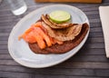 Salted salmon fillet with buckwheat pancakes and lime Royalty Free Stock Photo