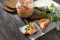 Salted salmon fillets with sea salt and butter on rye bread. Royalty Free Stock Photo
