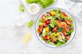 Salted salmon salad with fresh green lettuce, cucumbers, tomato, bell pepper and red onion. Ketogenic, keto or paleo diet lunch Royalty Free Stock Photo