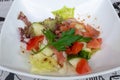 Salted salmon salad with tomatoes and cucumbers with soy sauce.