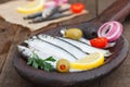 Salted sardines in wooden plate